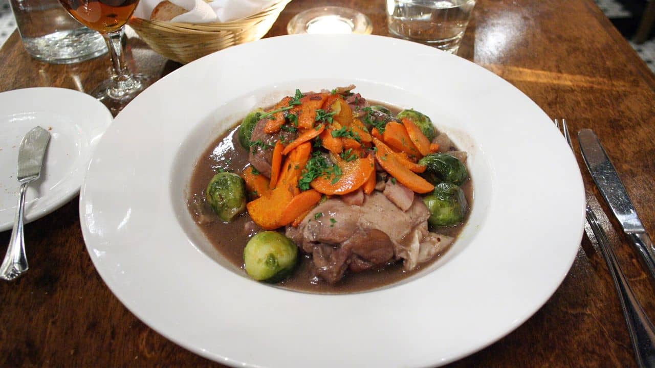 Braised Hen in Red Wine with Glazed Carrots and Brussel Sprouts from Jules Restaurant in Gastown, Vancouver, BC, Canada.