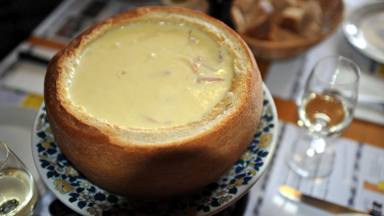Swiss cheese fondue in bread bowl.