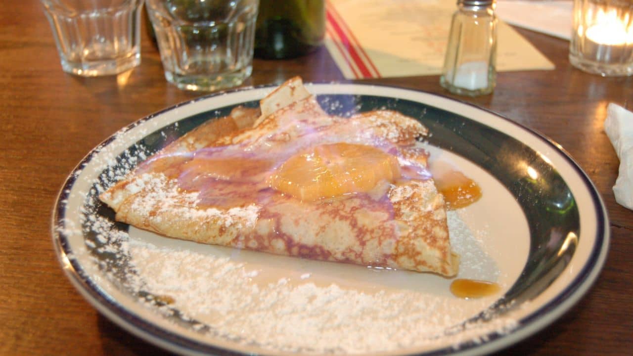 Crêpe Suzette au Citron with visible flame as served by Torchon Crêperie, Auckland.
