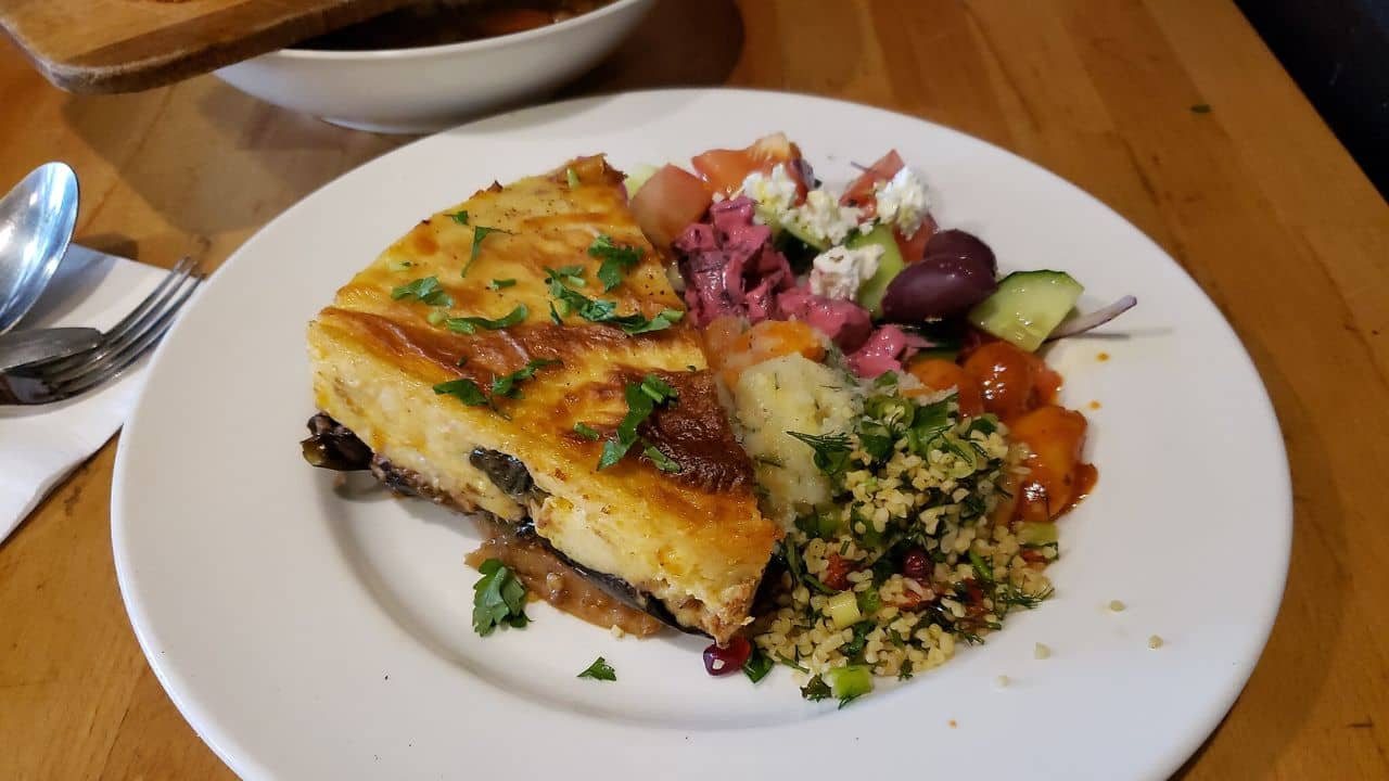 Meat moussaka: Layered vegetable bake with bechamel + mince lamb with all salads.