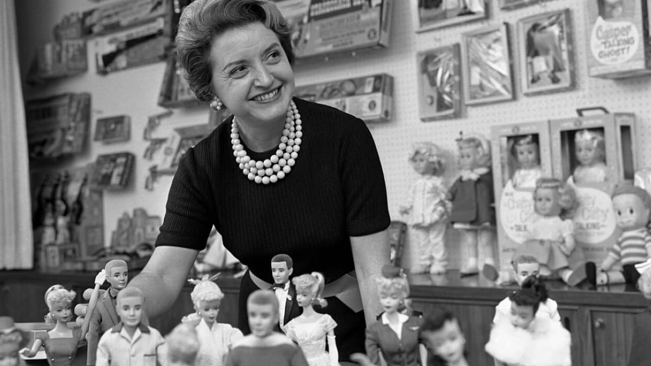 Ruth Handler, executive of Mattel Toy company, posing with collection of Barbie dolls, 1961